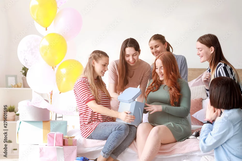 Women opening gifts at baby shower