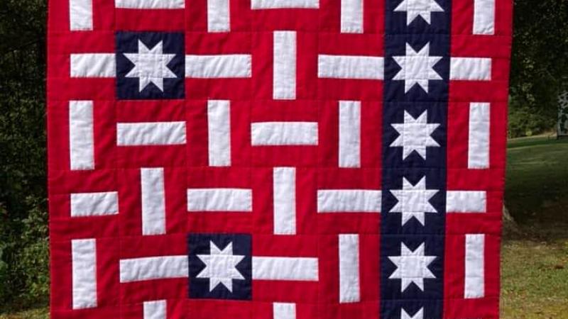 red white and blue quilt with stars